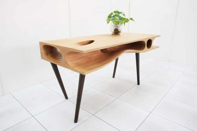 The table serves primarily as a piece of furniture that gives the room added value and multifunctionality. 