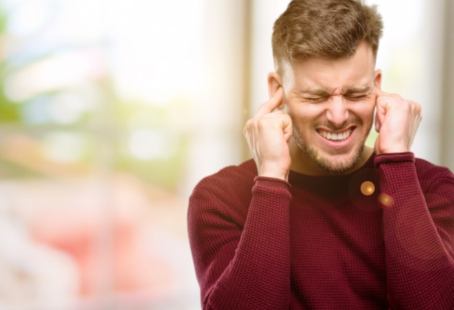 Listening to music without headphones in a public place.