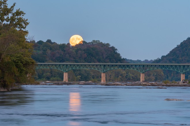 Księżyc myśliwego nad rzeką Potomac i mostem łączącym Maryland i Wirginię w USA.